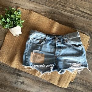 Levi’s cutoff jean shorts with patchwork detail. Size 28.